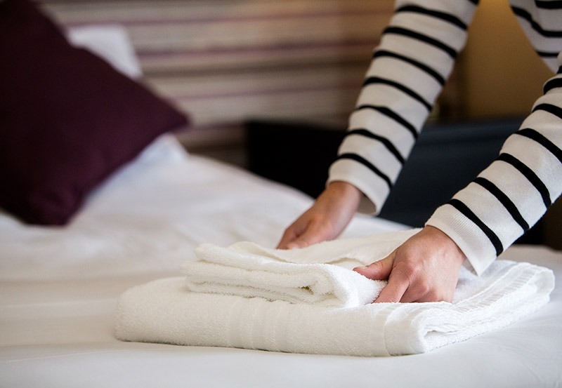 Housekeeper making beds